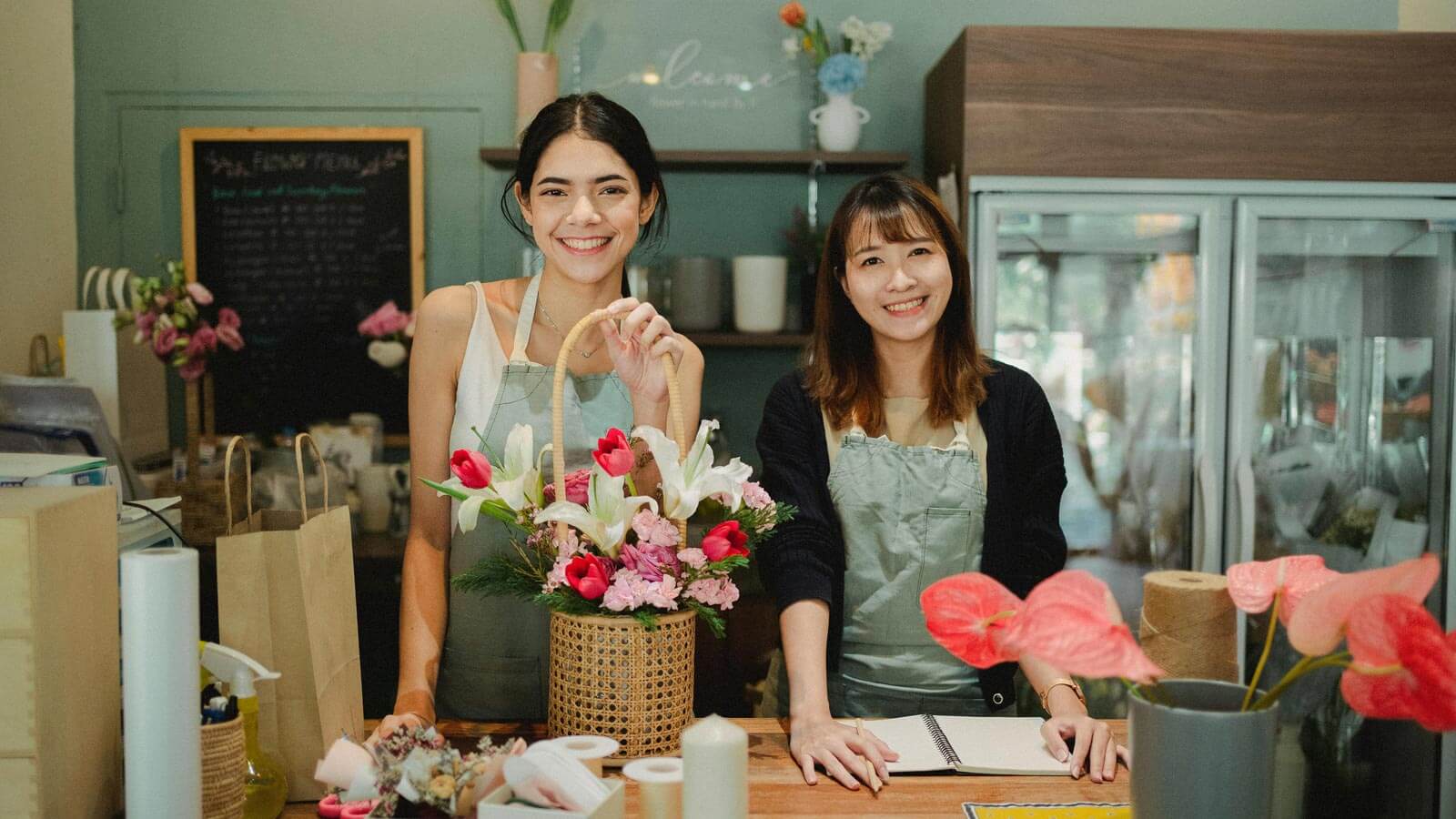 This is an image of two happy women standing in their flower shop